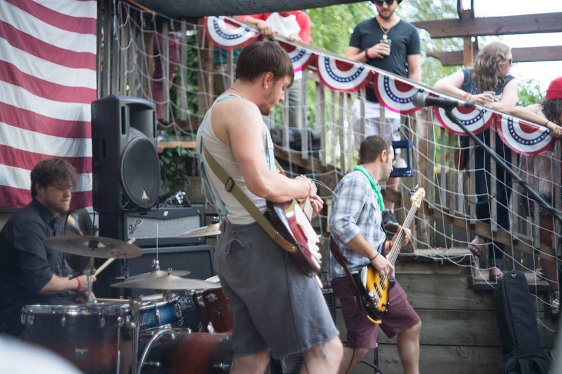 Walking Stalking Robots (Tarl Heddleston , Paul Hubbard and Scott Warner)  preforming on a stage for the US holiday Indenpence Day, or the Fourth of July.